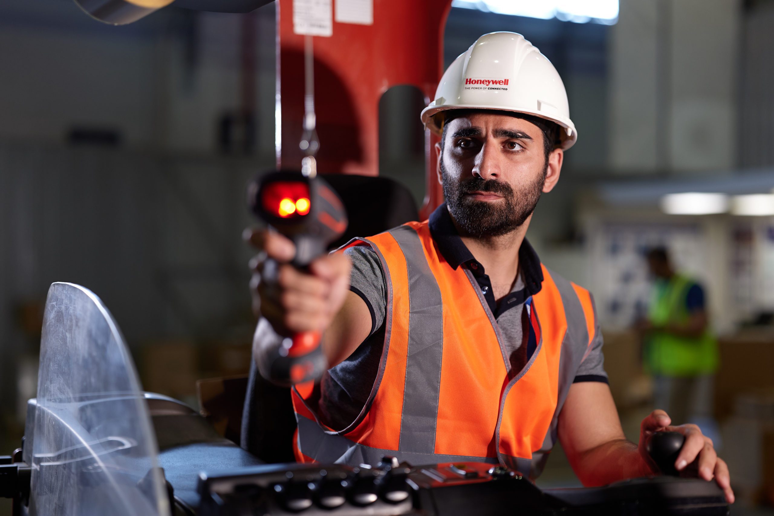 Warehouse associate scanning inventory with a handheld barcode scanner